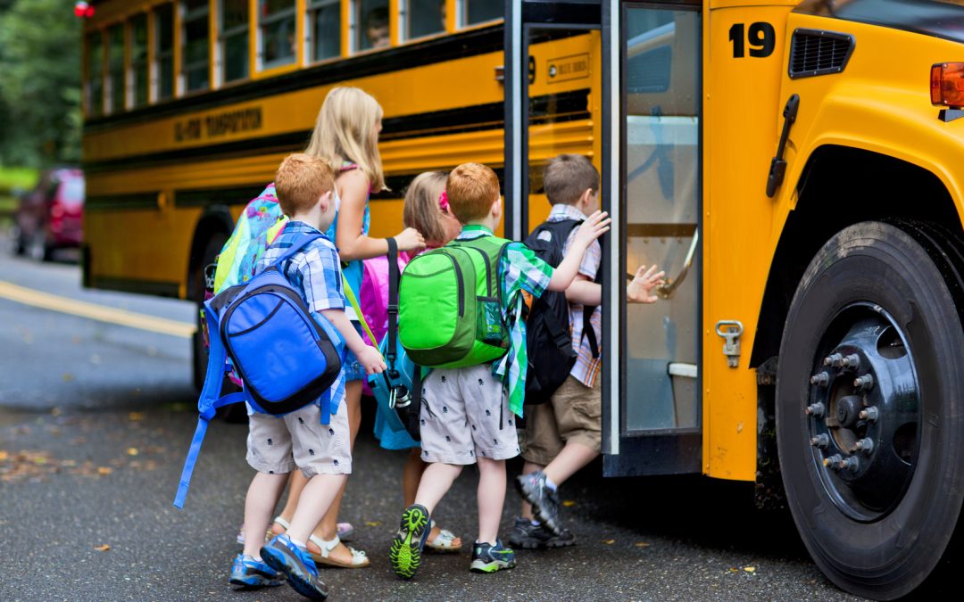 Educational Institutions | young children getting on school bus | Cost Control Associates