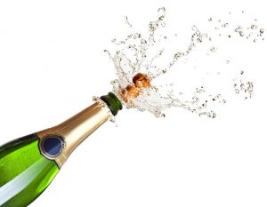 detail of popping champagne on black background