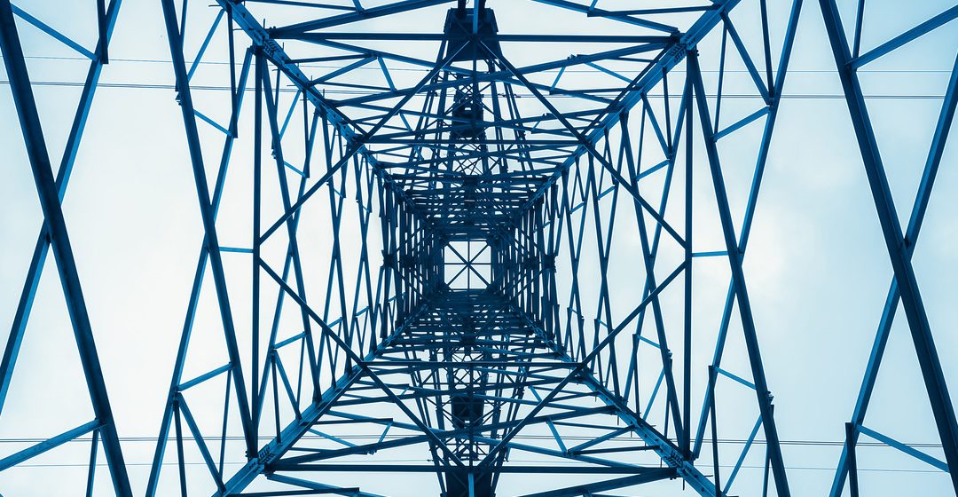 View of electricity tower from the vantage point of standing beneath it and looking up