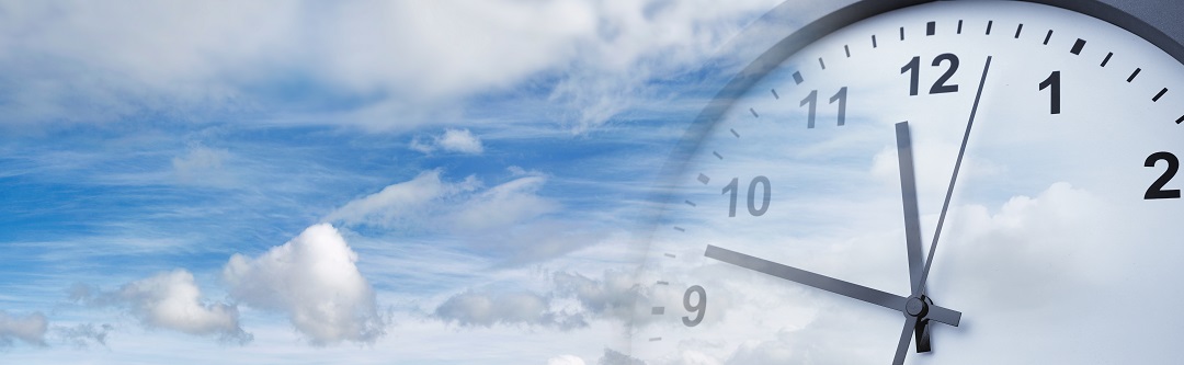 Daylight Savings Time | Clock superimposed over blue sky | Cost Control Associates