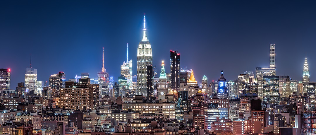 Why businesses measure GHG emissions | NYC skyline at night | Cost Control Associates