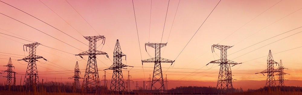 Energy Cost Managment | Electricity towers at dusk | Cost Control Associates